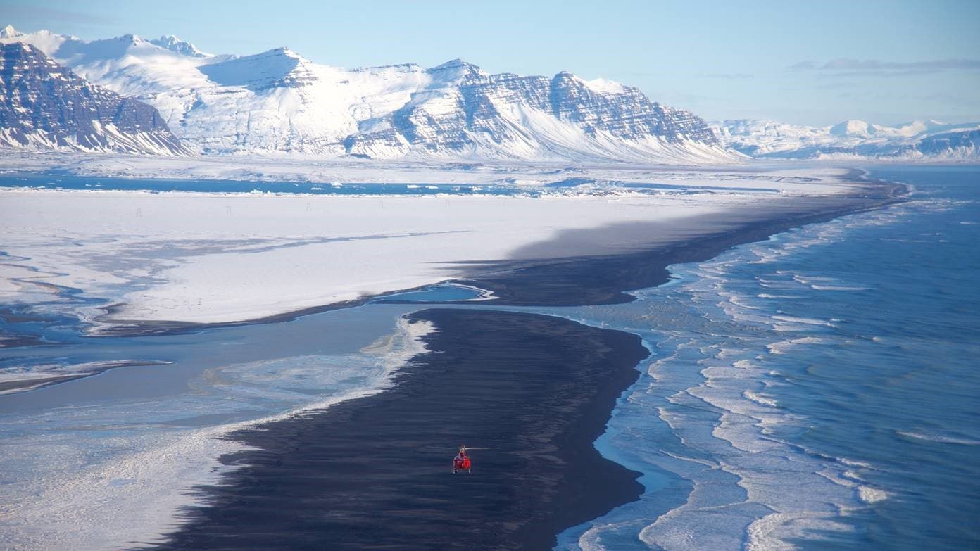 Helicopter flying over a mountain range
